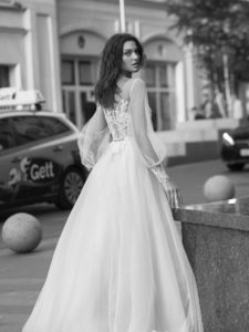 Bishop sleeve A-line wedding dress with illusion neckline and lace detailing on the bodice