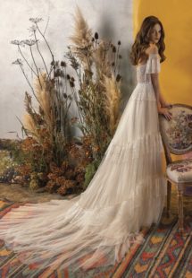 Style #2020, A-line wedding dress with ruffled skirt and off-the-shoulder bell sleeves, available in ivory