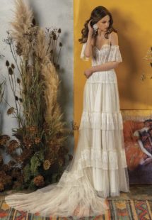 Style #2020, A-line wedding dress with ruffled skirt and off-the-shoulder bell sleeves, available in ivory