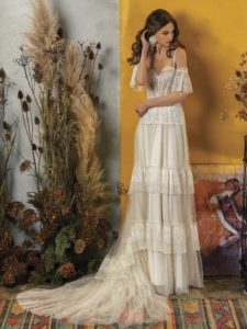 A-line wedding dress with ruffled skirt and off-the-shoulder bell sleeves