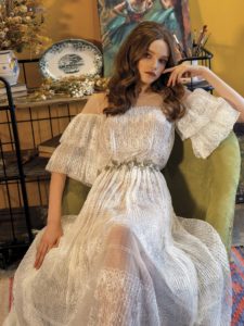 Lace wedding dress with ruffled bell sleeves, available in ivory on a nude base, ivory