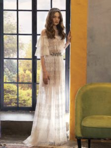 Lace wedding dress with ruffled bell sleeves, available in ivory on a nude base, ivory
