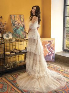 A-line wedding dress with off-the-shoulder neckline and ruffled layers