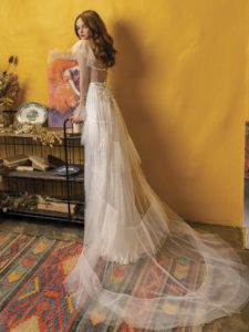 Wedding dress with long sleeves and ruffled skirt