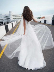 Bridal gown with pearl embellishments and cape sleeves