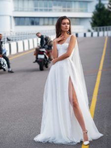 Bridal gown with pearl embellishments and cape sleeves