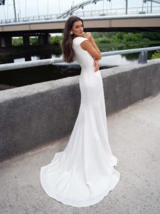 Modern bridal gown with wide V neckline and belt
