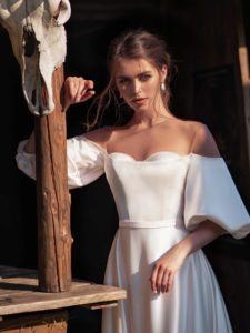 Off-the-shoulder wedding dress with bishop sleeves