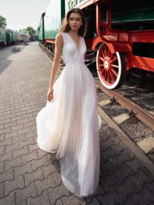 A-line bridal gown with a plunging neckline, available in ivory, dark ivory