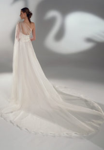 Style #2101, A-line wedding dress with one-shoulder cape sleeve, available in ivory