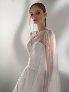A-line wedding dress with one-shoulder cape sleeve