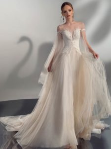 A-line wedding dress with cape sleeves, available in cream, ivory