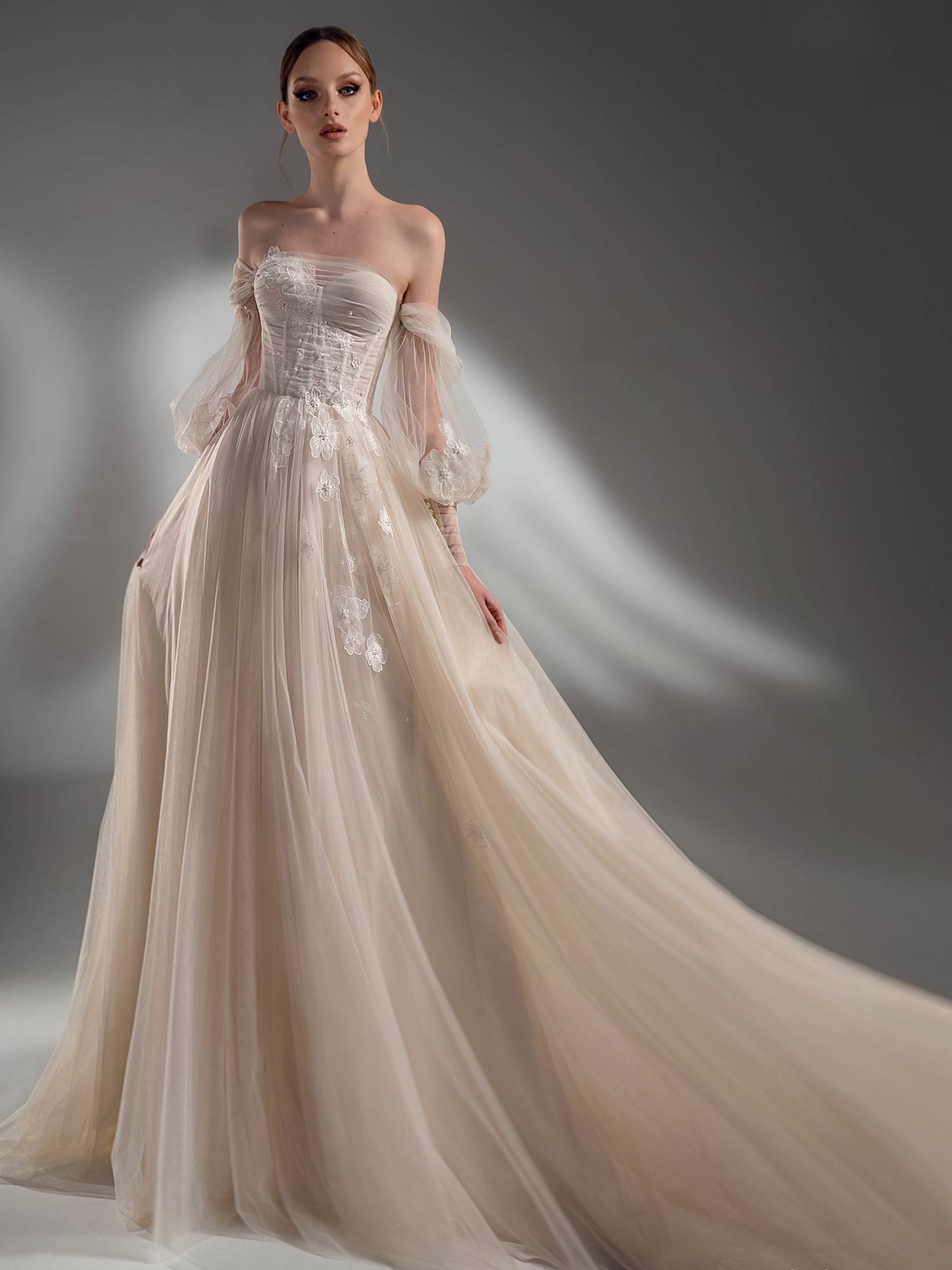 Style #2121, off the shoulder A-line wedding dress with detachable sleeves, available in cream–nude, ivory