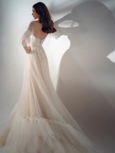 Style #2122, three-quarter sleeve A-line wedding dress with ruffles, available in cream-nude, ivory