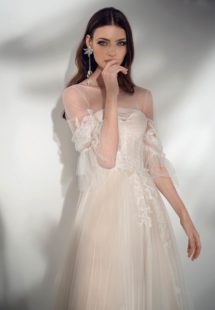 Style #2122, three-quarter sleeve A-line wedding dress with ruffles, available in cream-nude, ivory