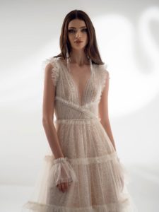 Shimmering A-line wedding dress with ruffles, available in ivory-nude, ivory