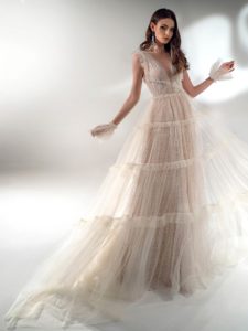 Shimmering A-line wedding dress with ruffles, available in ivory-nude, ivory