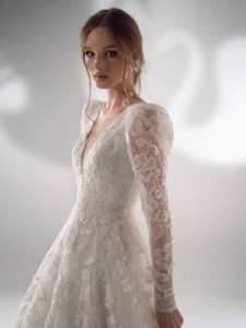 Cream sparkly lace ball gown wedding dress with long sleeves
