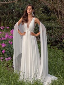 Plunging neckline chiffon wedding dress with detachable cape sleeves and open back; available in ivory, peach, sky blue