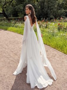 Plunging neckline chiffon wedding dress with detachable cape sleeves and open back; available in ivory, peach, sky blue
