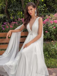 Plunging neckline chiffon wedding dress with detachable cape sleeves and open back; available in ivory, peach, sky blue