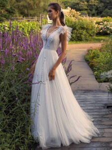White glitter tulle A-line wedding dress with ruffled cap sleeves and open back