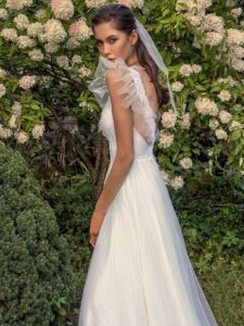 White glitter tulle A-line wedding dress with ruffled cap sleeves and open back