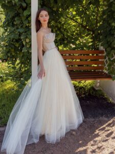 Strapless A-line wedding dress with frilled tulle neckline and sequinned bodice; available in ivory-nude, ivory