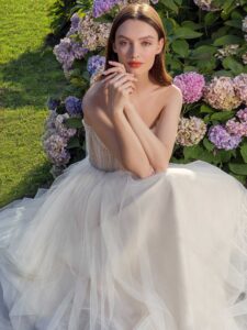 Strapless A-line wedding dress with frilled tulle neckline and sequinned bodice; available in ivory-nude, ivory