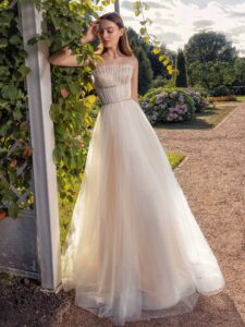 Strapless A-line wedding dress with frilled tulle neckline and sequinned bodice; available in ivory-nude, ivory