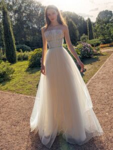 Strapless A-line wedding dress with frilled tulle neckline and sequinned bodice; available in ivory-nude, ivory