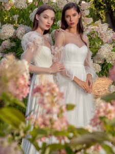 Long-sleeve sheath wedding dress with extended shoulders and Tulle A-line wedding dress with floral sleeves