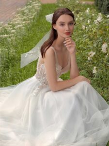 A-line wedding dress with bustier style corset, floral decor and pockets; available in ivory-nude, ivory