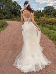 A-line wedding dress with bustier style corset, floral decor and pockets; available in ivory-nude, ivory