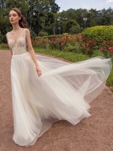 A-line wedding dress with bustier style corset, floral decor and pockets; available in ivory-nude, ivory