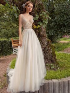 A-line wedding dress with bustier style corset, floral decor and pockets; available in ivory-nude, ivory