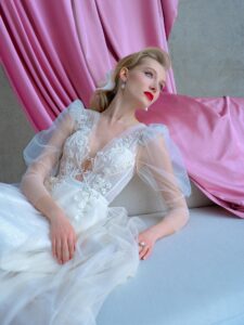 Shimmering tulle A-line wedding dress with long puffed sleeves and floral embroidery