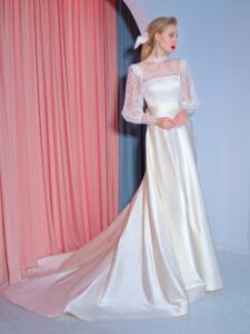 Long-sleeve A-line wedding gown with atlas skirt, lace high-neck top and oversized bow decor