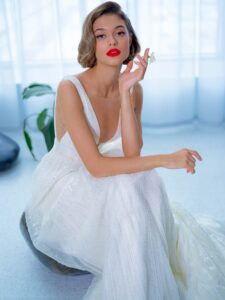 Sequinned lace A-line wedding dress with plunging V-neckline and belt