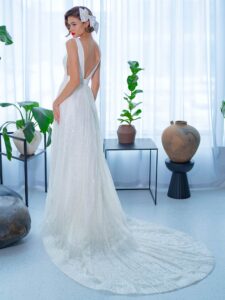 Sequinned lace A-line wedding dress with plunging V-neckline and belt