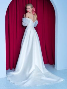 Long-sleeve A-line wedding dress with bishop style sleeves and high slit skirt