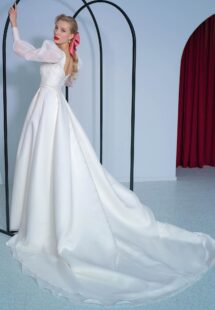 Style #2216L, long-sleeve A-line wedding dress with bishop style sleeves and high slit skirt, available in ivory