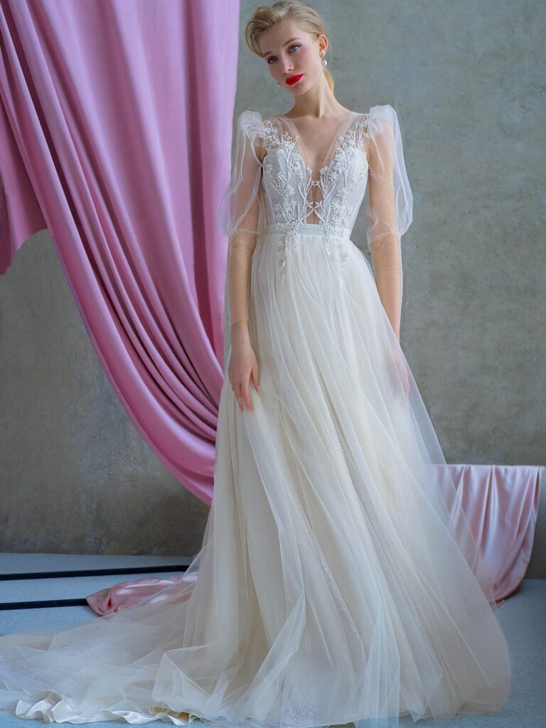 Style #2225, shimmering tulle A-line wedding dress with long puffed sleeves and floral embroidery, available in ivory