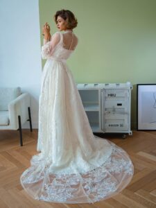 Tulle overlay dress with a high neck, long bishop sleeves and floral lace embroidery; comes with a satin inner dress