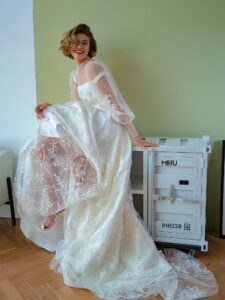 Tulle overlay dress with a high neck, long bishop sleeves and floral lace embroidery; comes with a satin inner dress