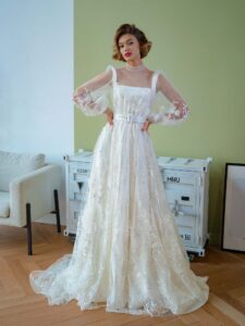 Tulle overlay dress with a high neck, long bishop sleeves and floral lace embroidery; comes with a satin inner dress