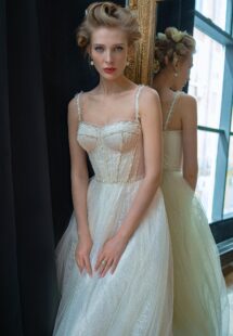 Style #2230L, sparkling lace A-line wedding dress with a beaded bustier top, available in ivory