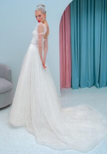 Style #2200L, A-line wedding dress with a plunging neckline, long sleeves and puffed shoulders, available in ivory