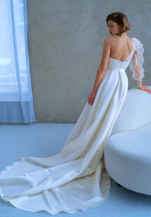 Style #2215L, one-sleeve ball gown wedding dress with high slit and pockets, available in ivory
