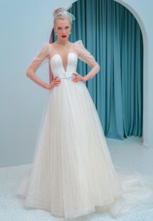 Style #2200L, A-line wedding dress with a plunging neckline, long sleeves and puffed shoulders, available in ivory